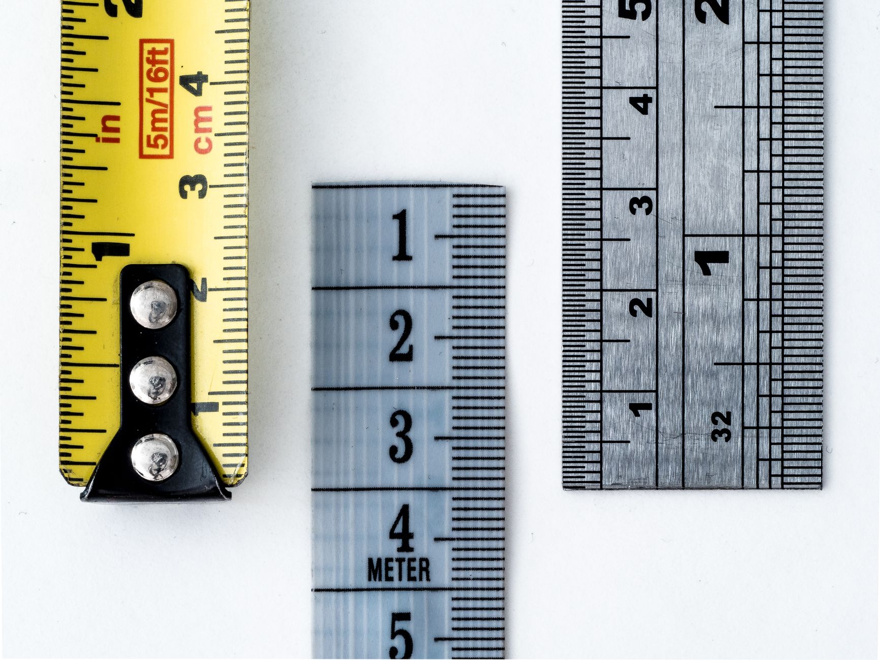 High-resolution image of a tape measure and rulers, showing precise millimeter, centimeter, and inch markings.