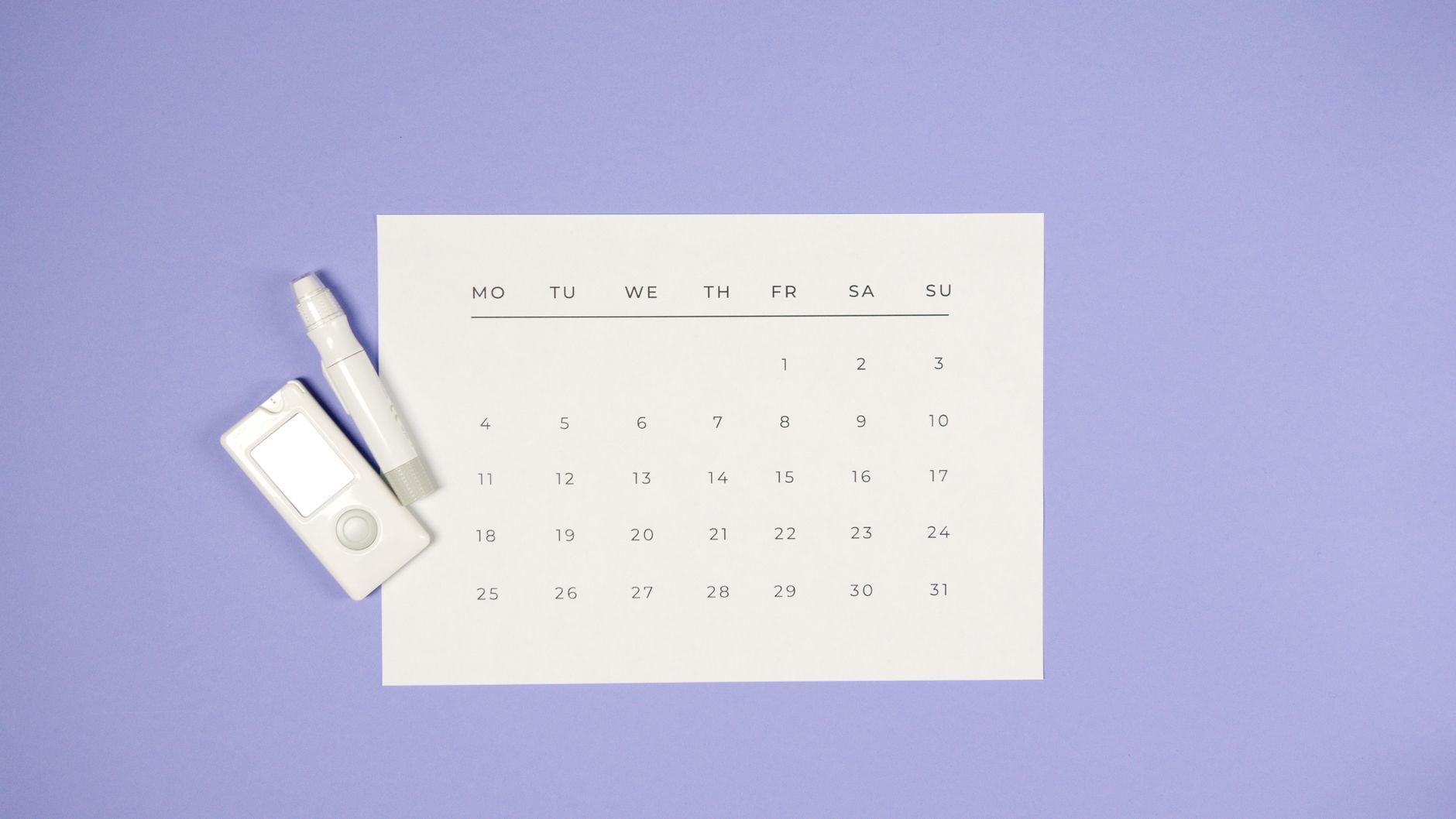 Minimalist setup of a glucometer, lancet pen, and calendar on a light purple background.