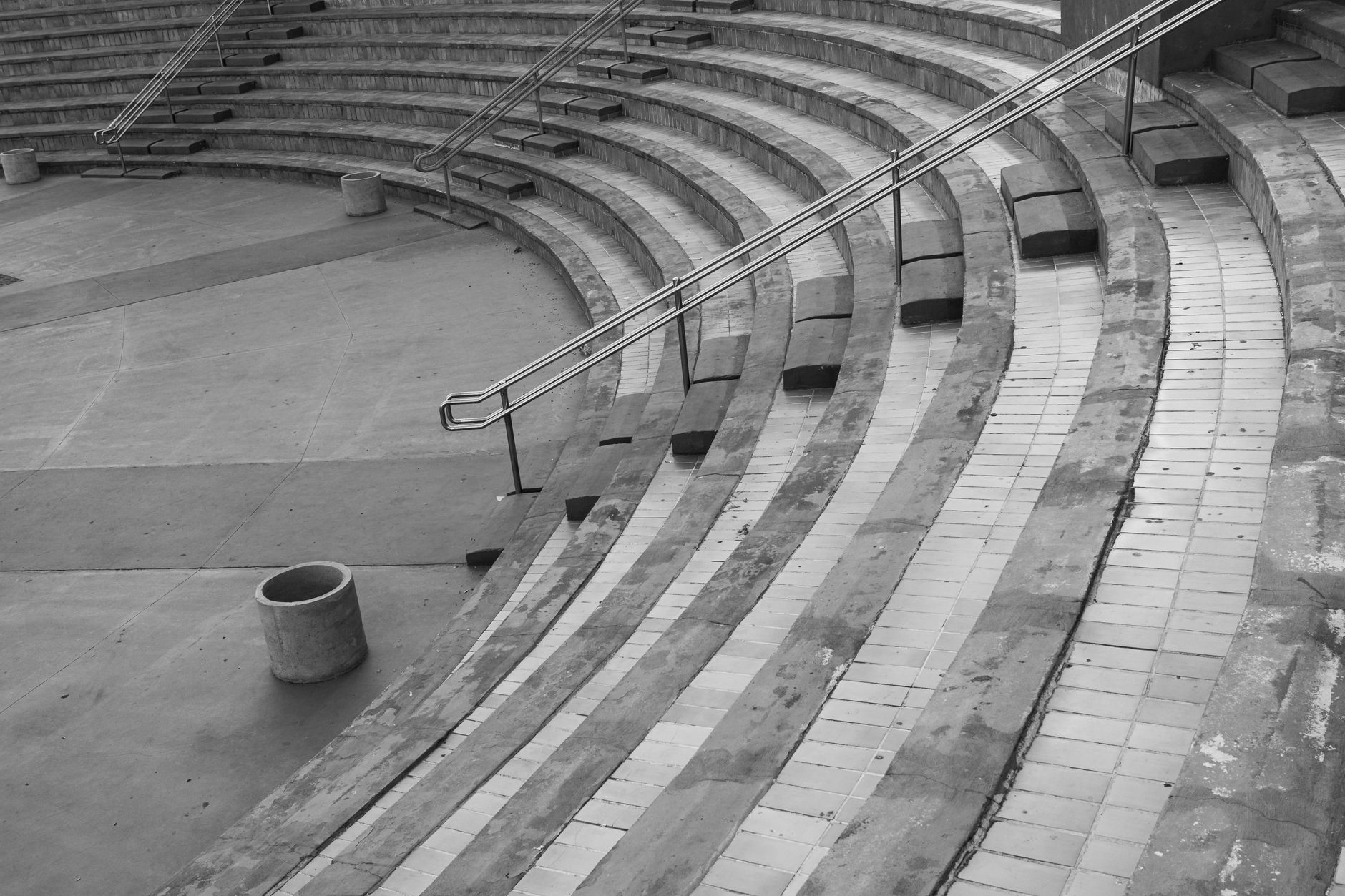 Empty curved amphitheater seating with stair details in black and white.