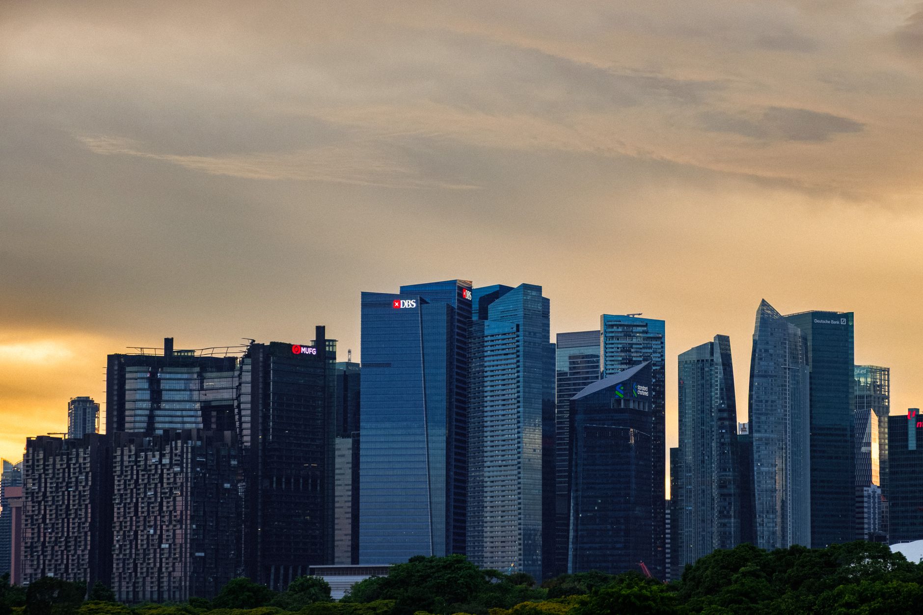 Dramatic sunset view of Singapore's skyline showcasing modern skyscrapers in the city center.