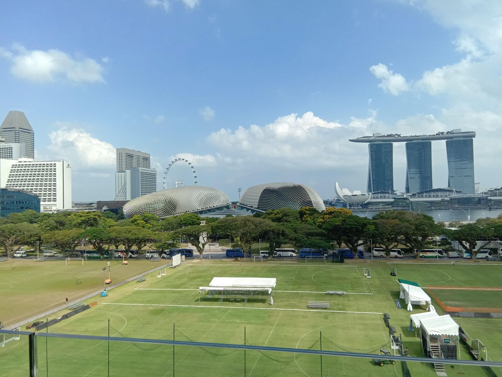 A scenic view of Singapore's iconic Marina Bay Sands and Esplanade against a clear sky.